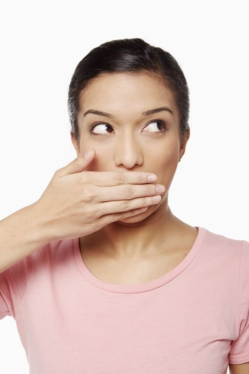 Woman covering her mouth