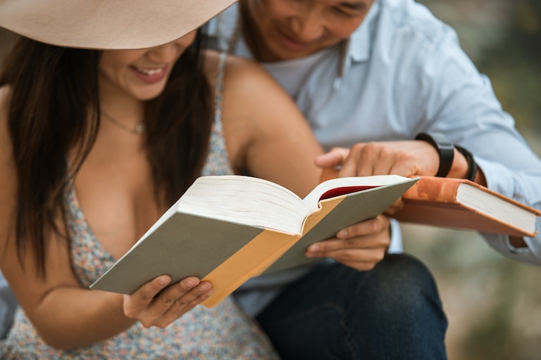 man and woman reading book